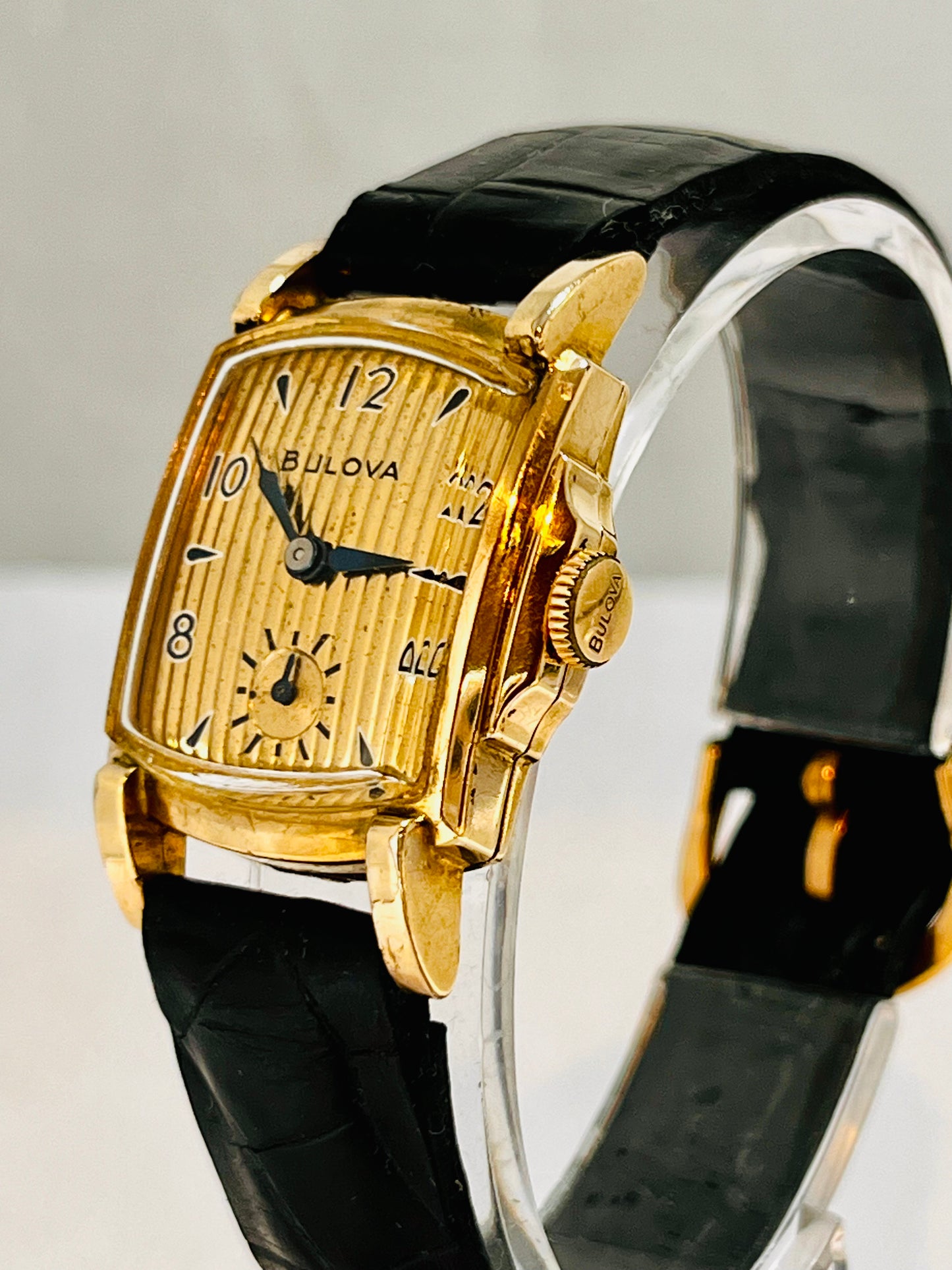 A vintage Bulova Academy Award Z watch with a gold-filled case, gold curtain dial, and vintage alligator black leather strap 